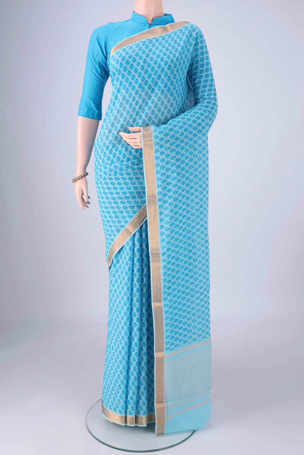 Sky Blue Mangalagiri Cotton Saree with Printed design on the body and Zari Border.  displayed on a mannequin