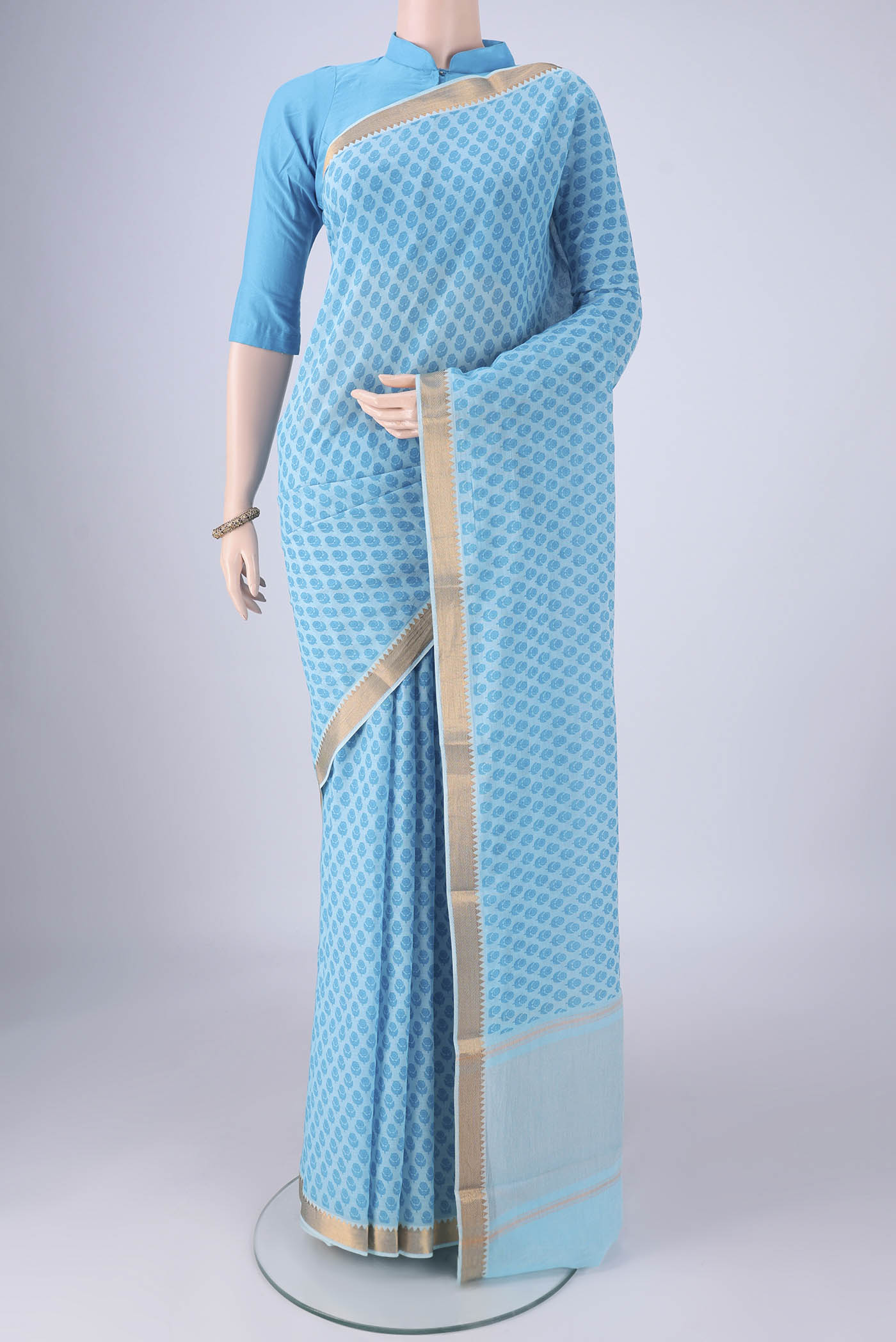 Sky Blue Mangalagiri Cotton Saree with Printed design on the body and Zari Border.  displayed on a mannequin
