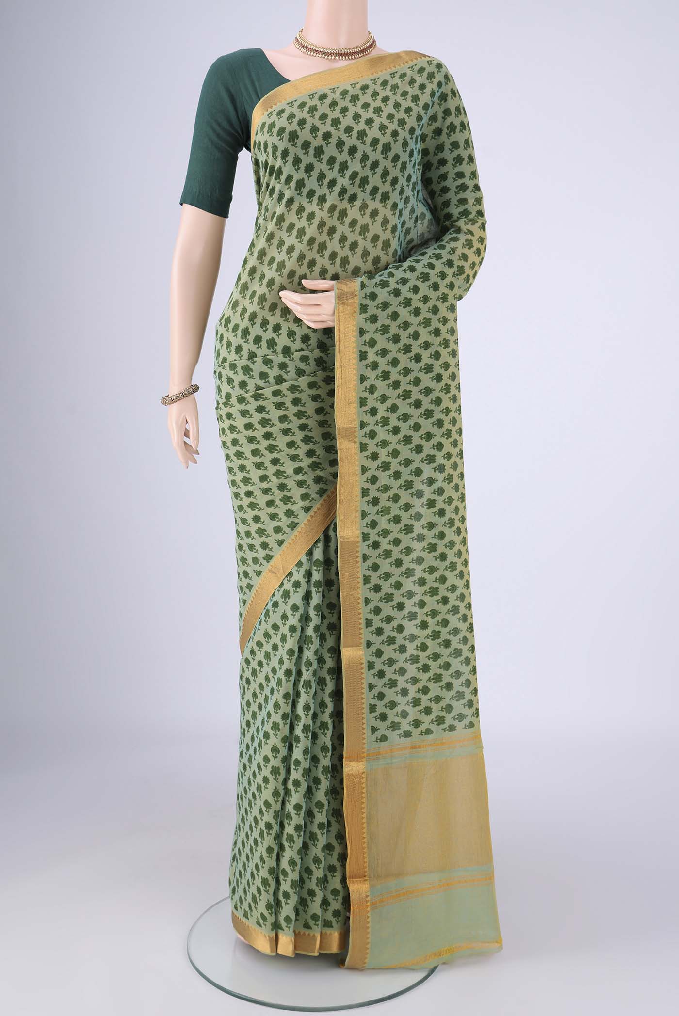 Green Mangalagiri Cotton Saree with Printed design on the body and Zari Border.  displayed on a mannequin