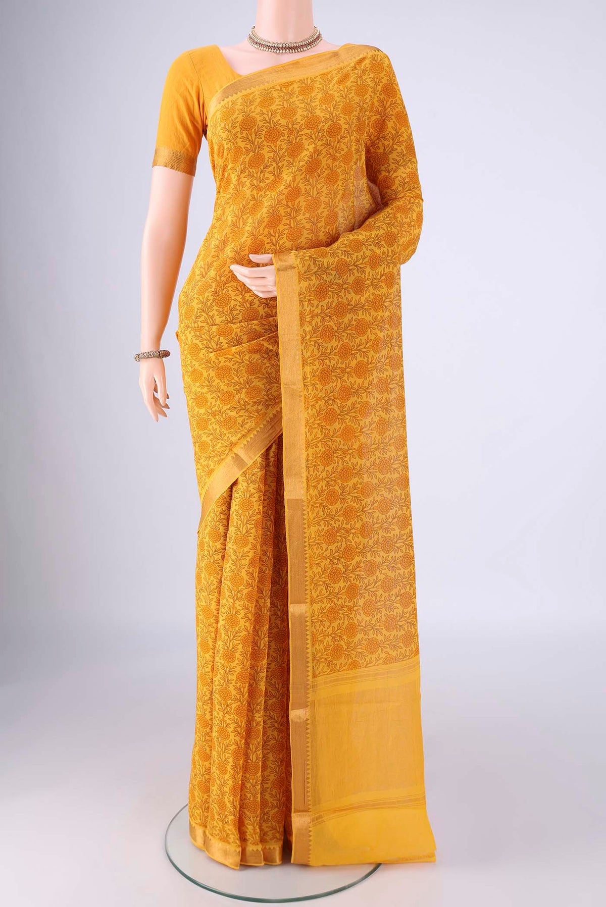 Yellow Mangalagiri Cotton Saree with Printed design on the body and Zari Border.  displayed on a mannequin