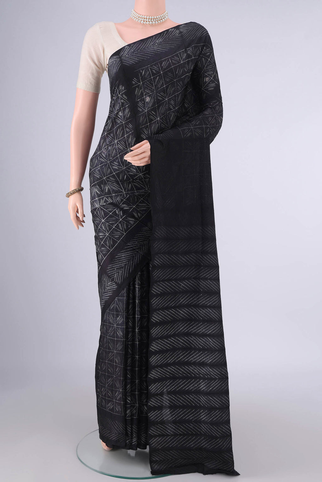 Pure Silk Black Printed Saree with Printed design on the body and Printed Border.  displayed on a mannequin