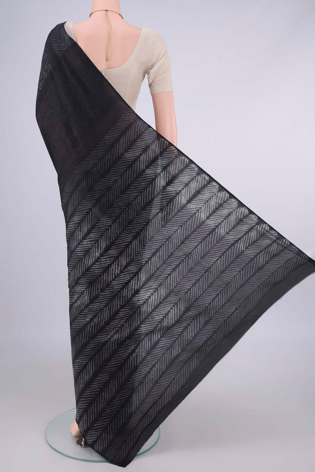 Flat view of Pure Silk Black Printed Saree with Printed design on the body and Printed Border. 
