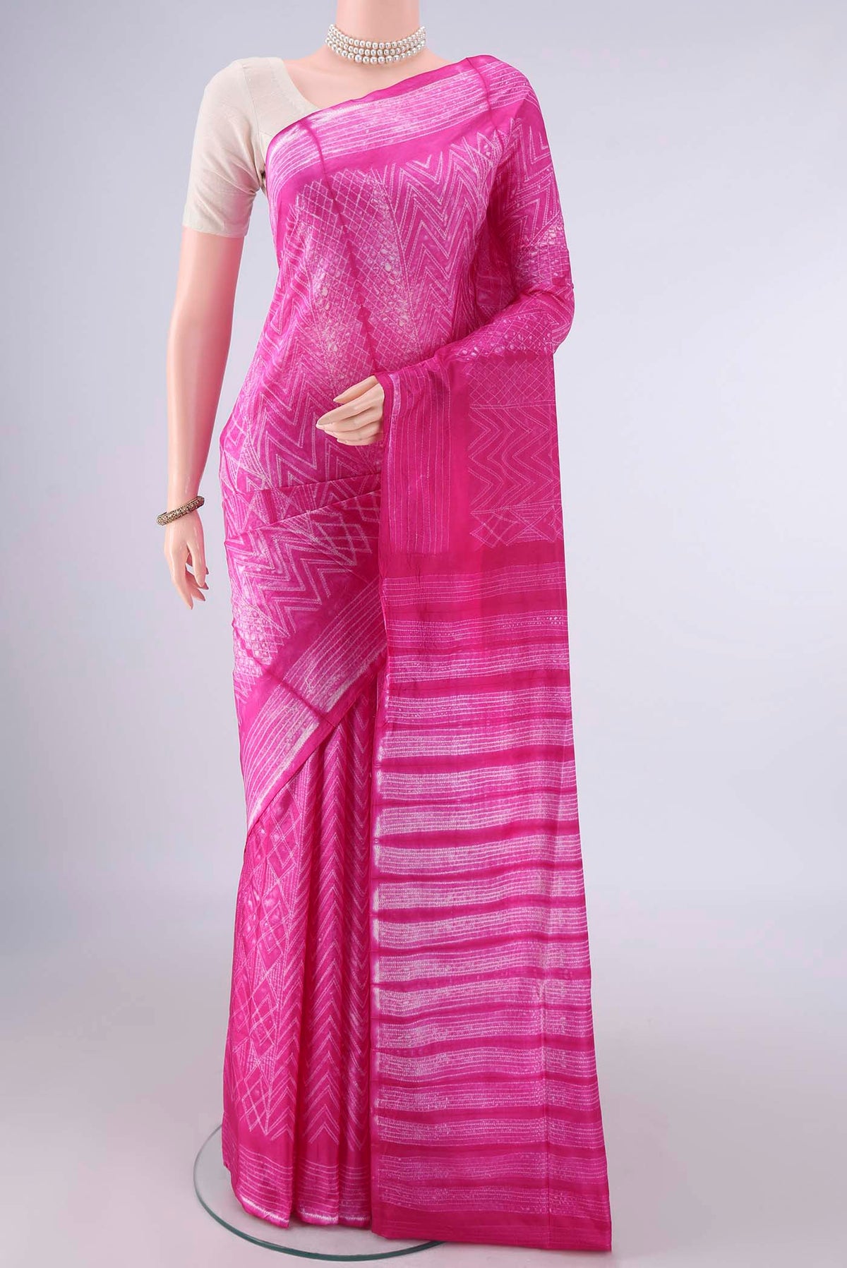 Pure Silk Rani Pink Printed Saree with Printed design on the body and Printed Border.  displayed on a mannequin