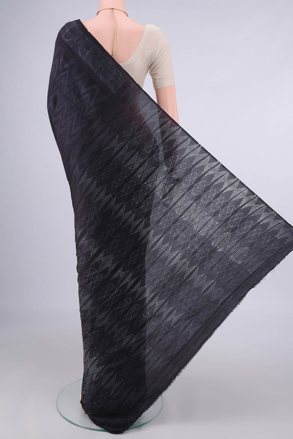 Flat view of Pure Silk Black Printed Saree with Printed design on the body and Printed Border. 