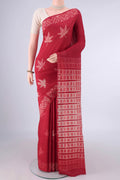 Red Tussar Saree with Printed design on the body and Printed Border.  displayed on a mannequin