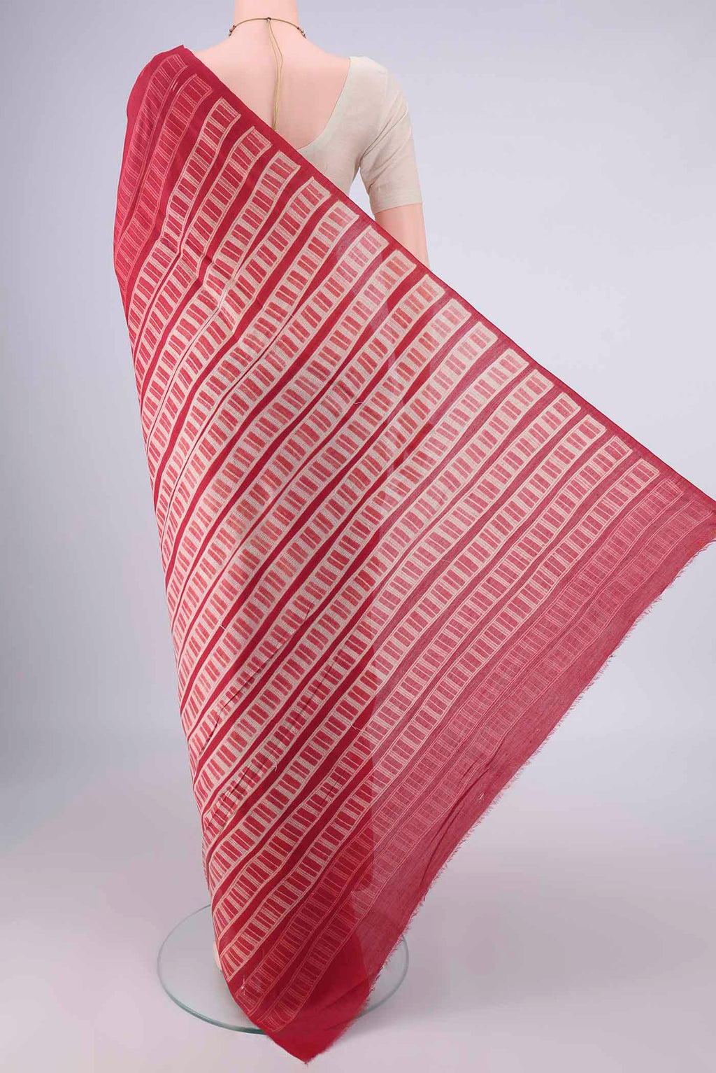Flat view of Red Tussar Saree with Printed design on the body and Printed Border. 