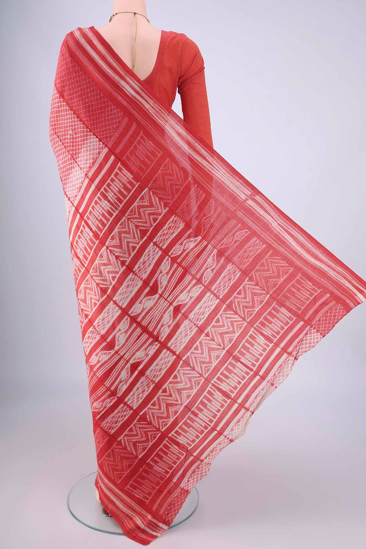 Flat view of Red Tussar Silk Saree with Zig Zag design on the body and Printed Border. 