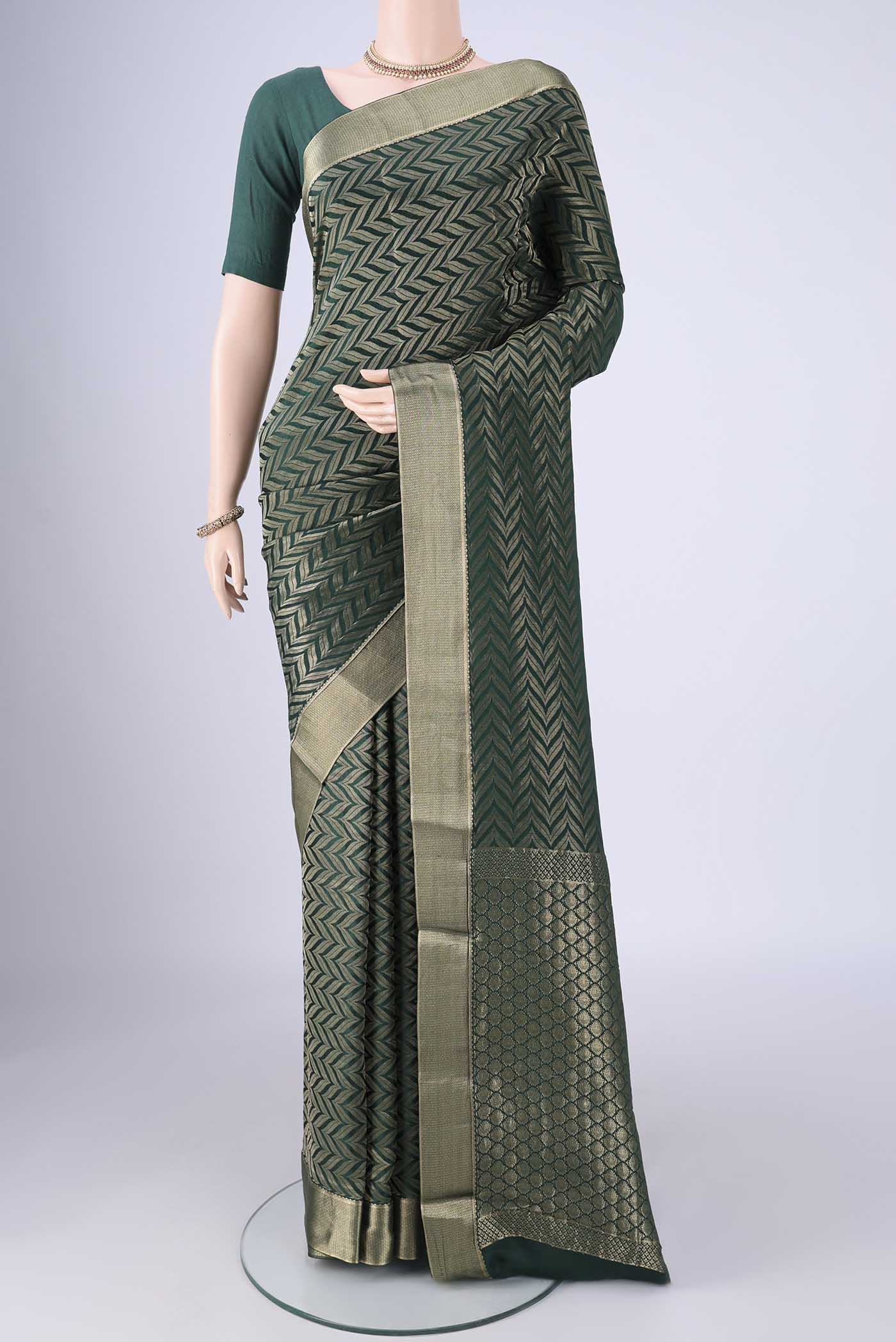 Bottle Green Mysore Crepe Saree with Zari Brocade on the body and Zari Border.  displayed on a mannequin