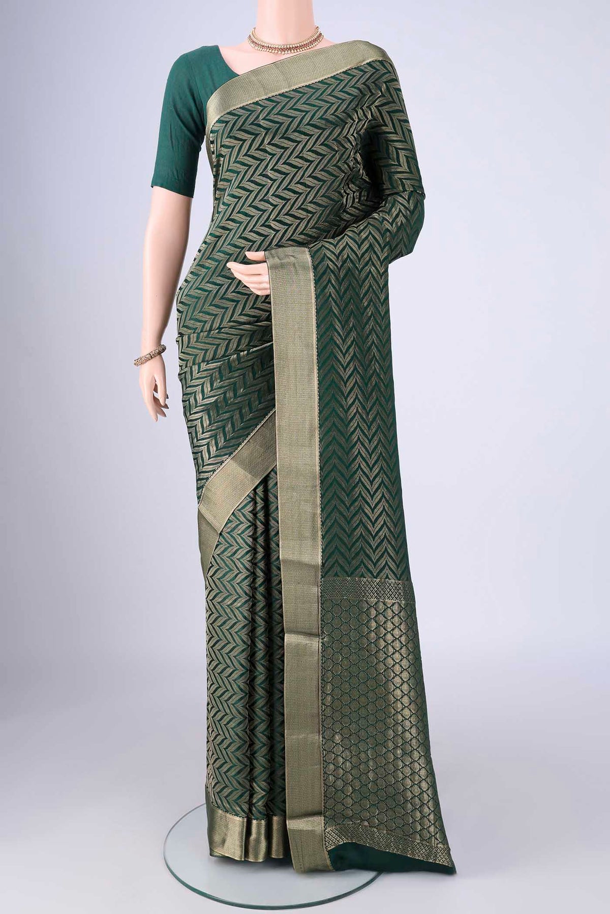 Bottle Green Mysore Crepe Saree with Zari Brocade on the body and Zari Border.  displayed on a mannequin
