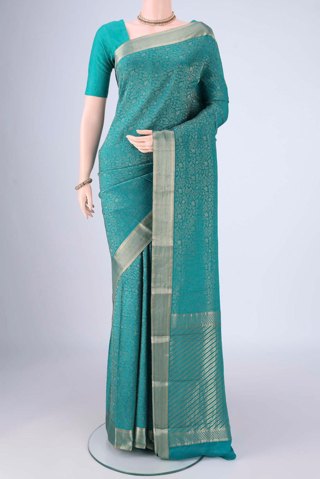 Sea Green Mysore Crepe Saree with Zari Brocade on the body and Zari Border.  displayed on a mannequin