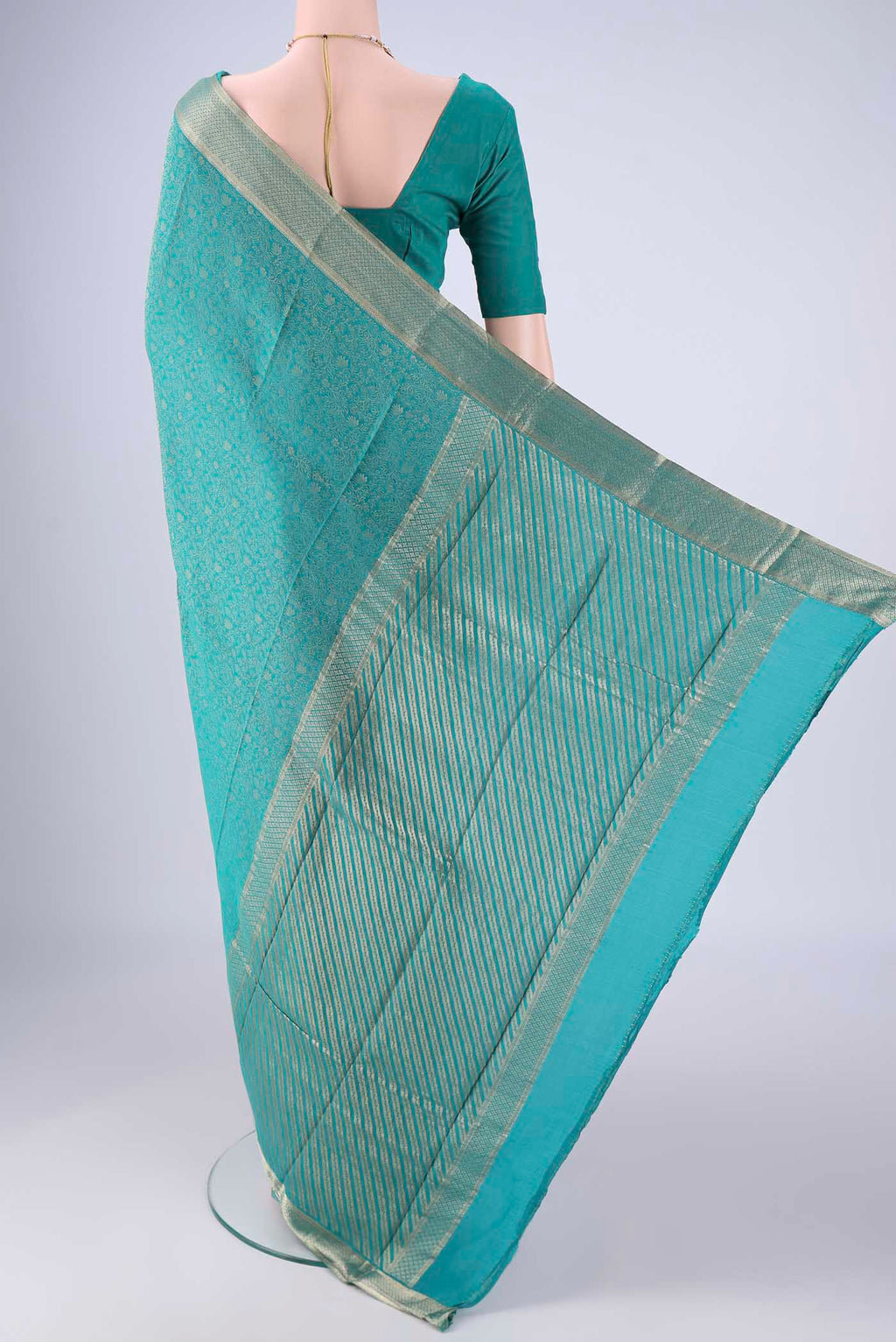 Flat view of Sea Green Mysore Crepe Saree with Zari Brocade on the body and Zari Border. 