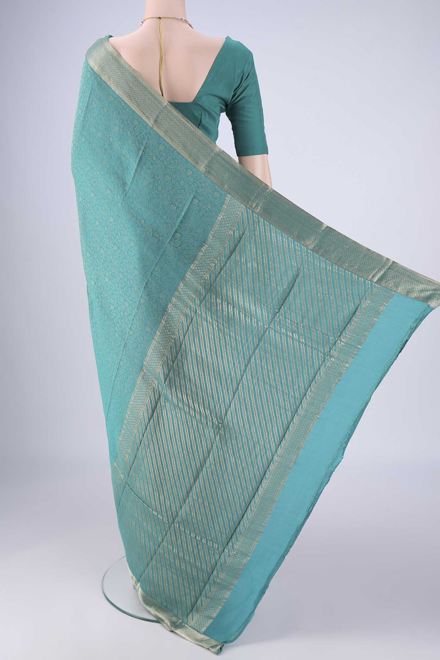 Flat view of Sea Green Mysore Crepe Saree with Zari Brocade on the body and Zari Border. 