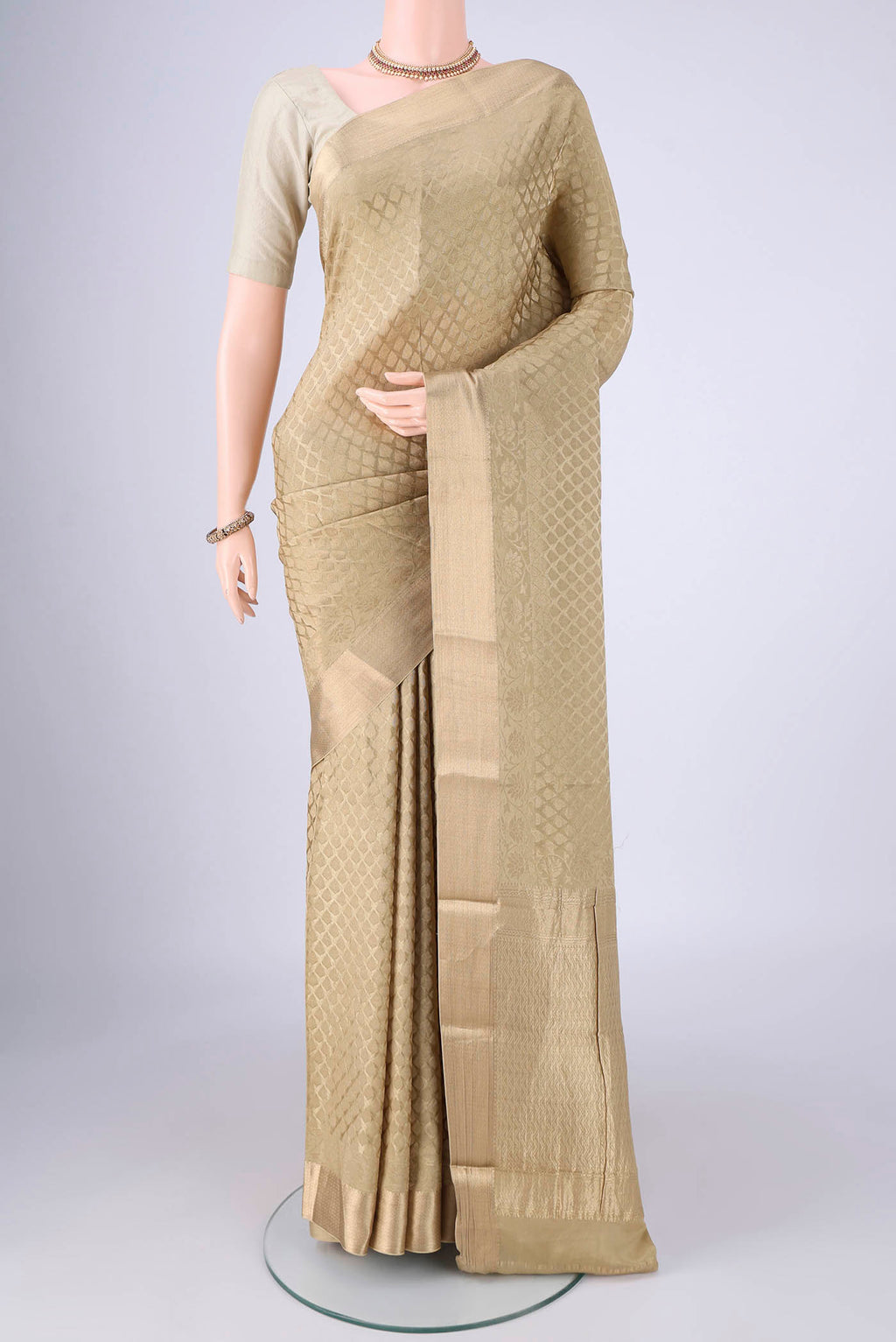 Dark Beige Mysore Crepe Saree with Zari Brocade on the body and Zari Border.  displayed on a mannequin