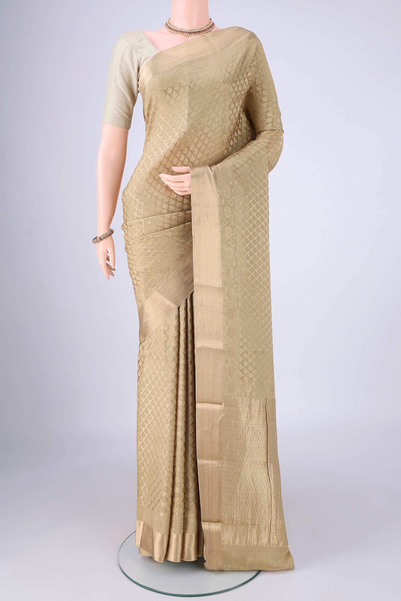 Dark Beige Mysore Crepe Saree with Zari Brocade on the body and Zari Border.  displayed on a mannequin