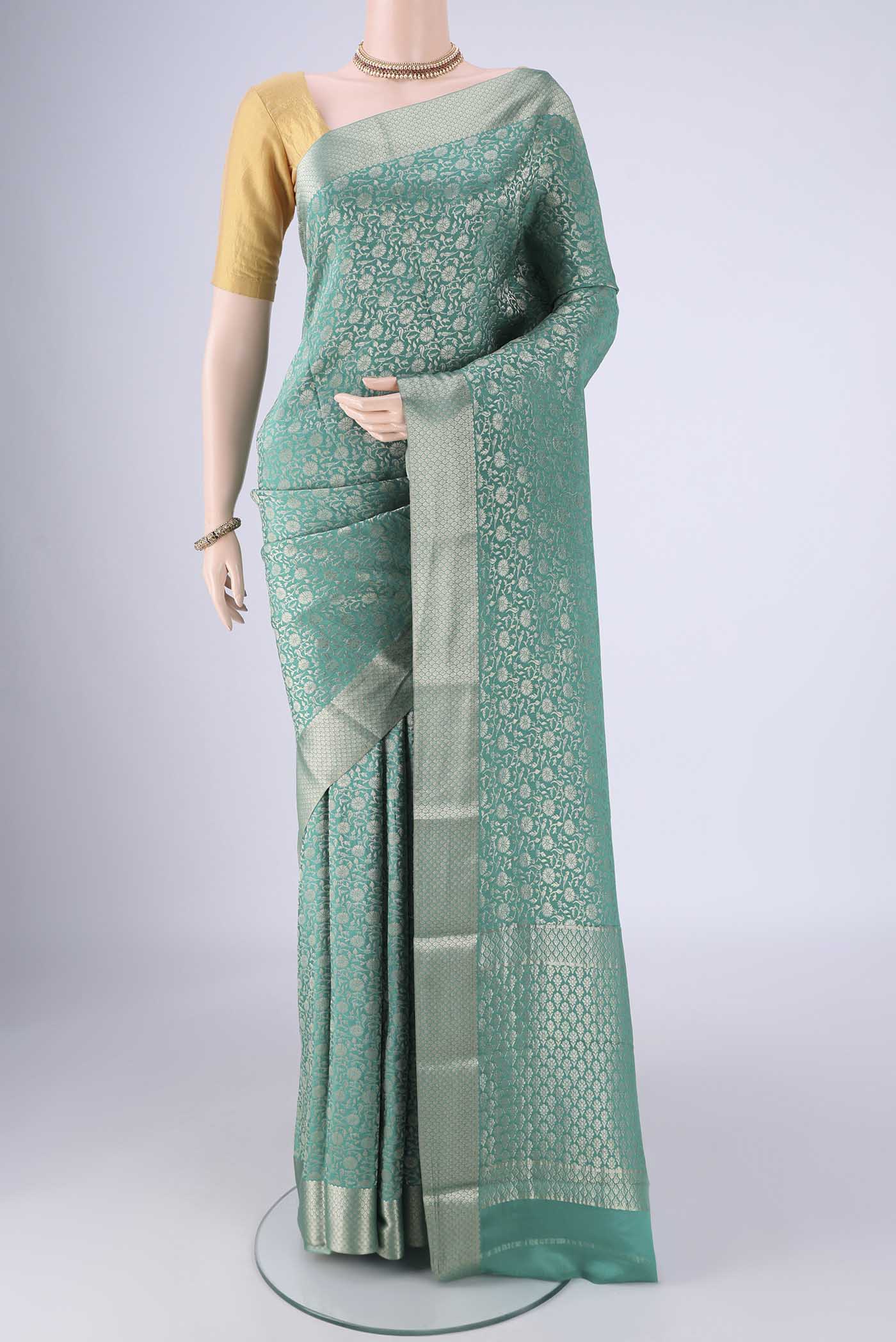 Sea Green Mysore Crepe Saree with Zari Brocade on the body and Zari Border.  displayed on a mannequin