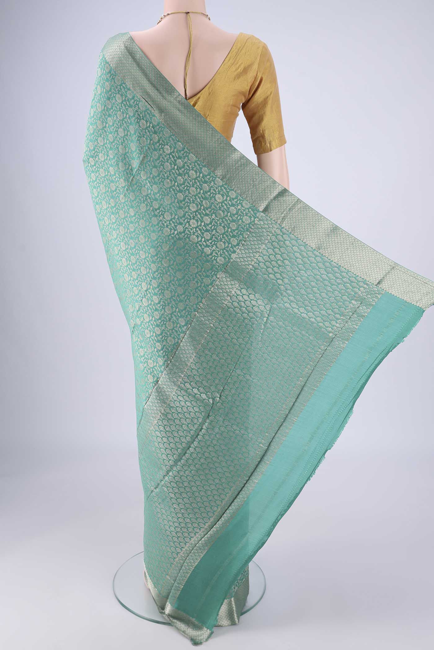 Flat view of Sea Green Mysore Crepe Saree with Zari Brocade on the body and Zari Border. 