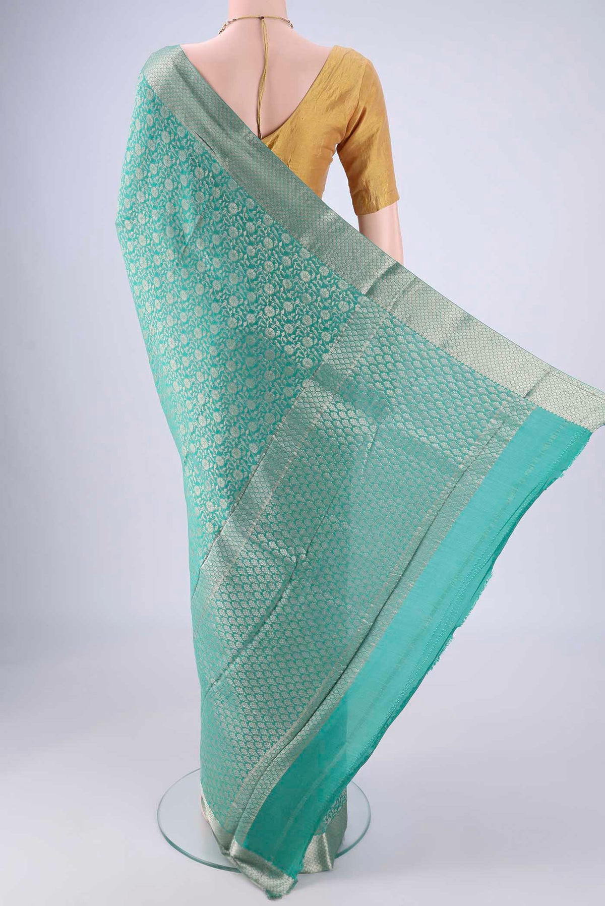 Flat view of Sea Green Mysore Crepe Saree with Zari Brocade on the body and Zari Border. 