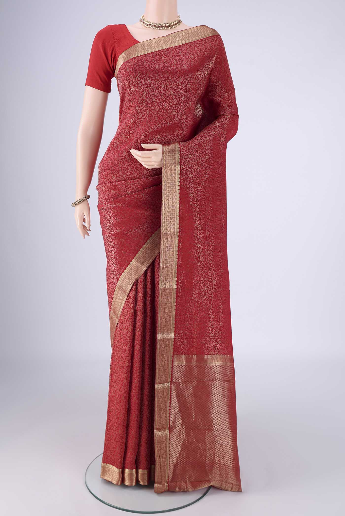 Red Mysore Crepe Saree with Zari Brocade on the body and Zari Border.  displayed on a mannequin