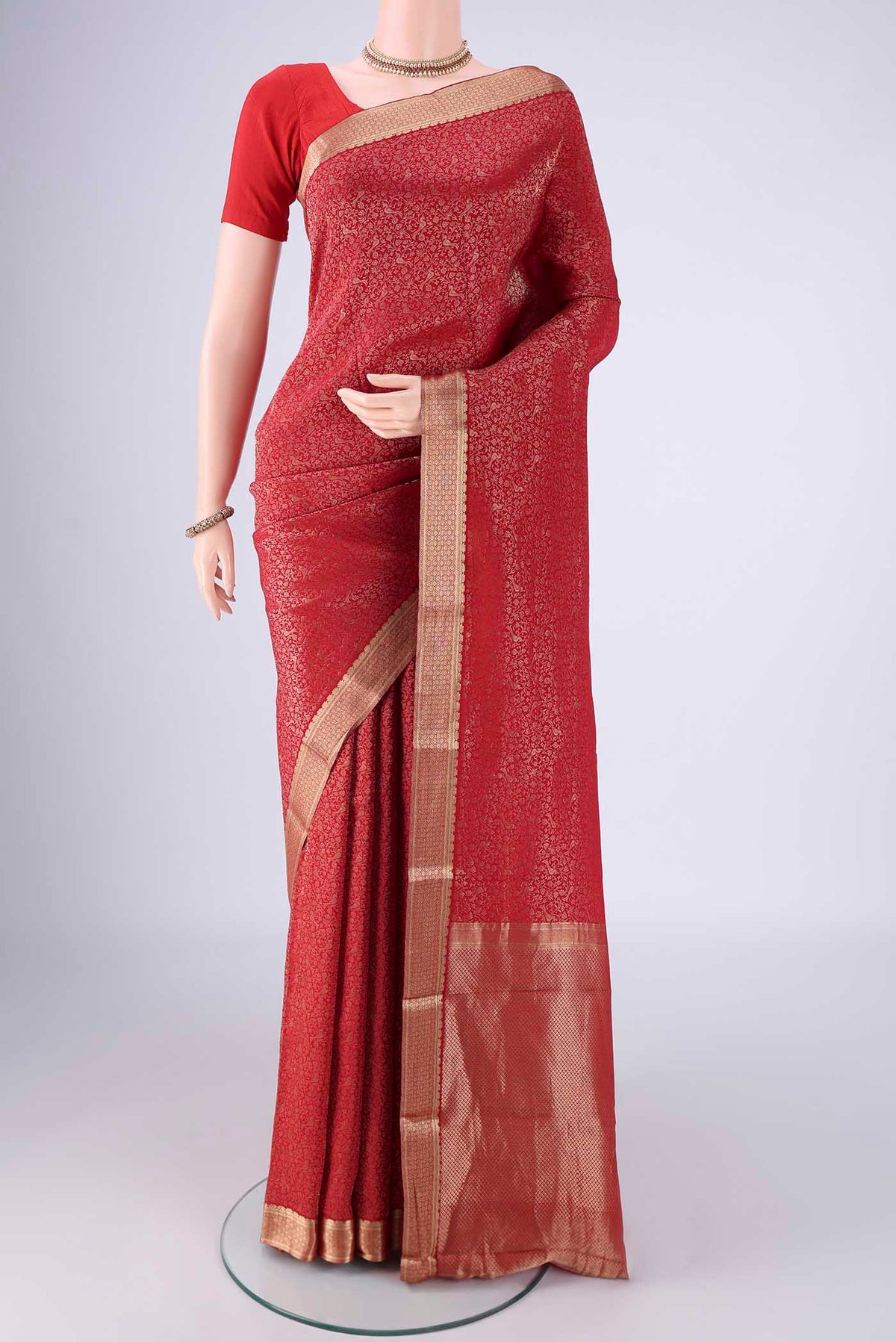 Red Mysore Crepe Saree with Zari Brocade on the body and Zari Border.  displayed on a mannequin