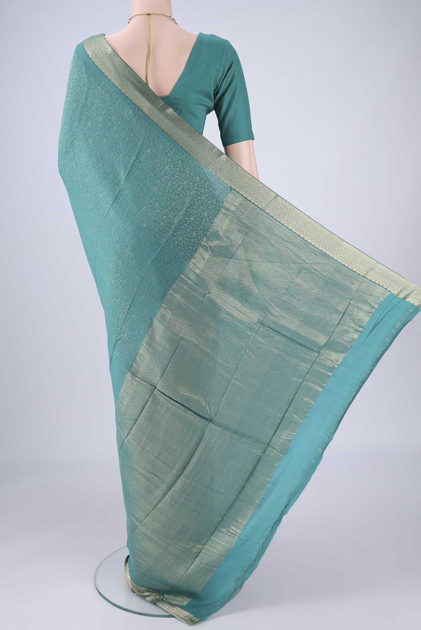 Flat view of Sea Green Mysore Crepe Saree with Zari Brocade on the body and Zari Border. 
