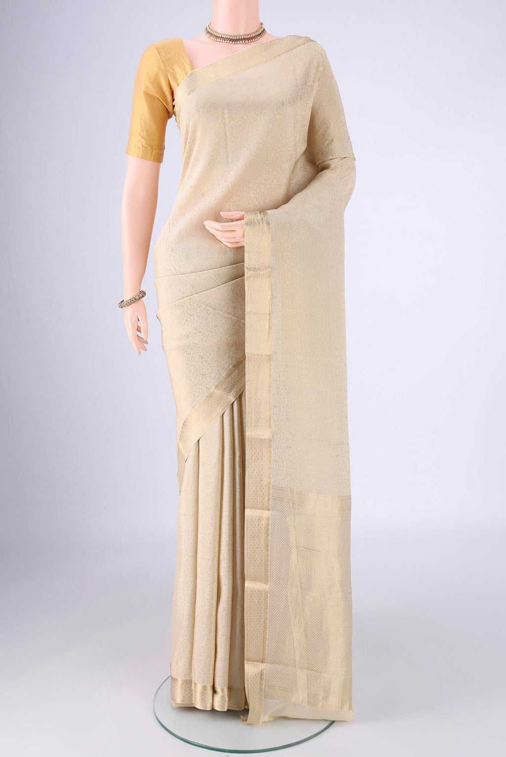 Cream Mysore Crepe Saree with Zari Brocade on the body and Zari Border.  displayed on a mannequin