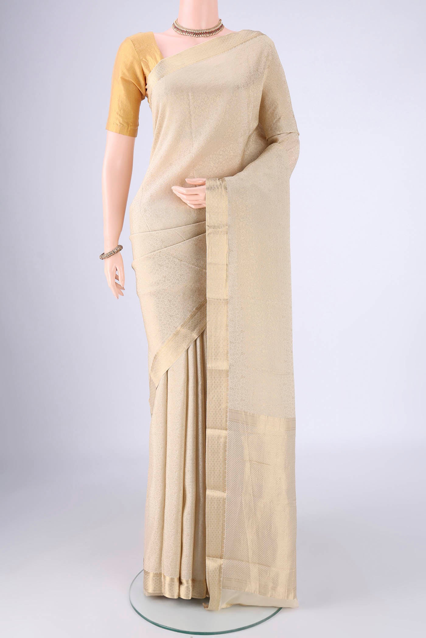 Cream Mysore Crepe Saree with Zari Brocade on the body and Zari Border.  displayed on a mannequin