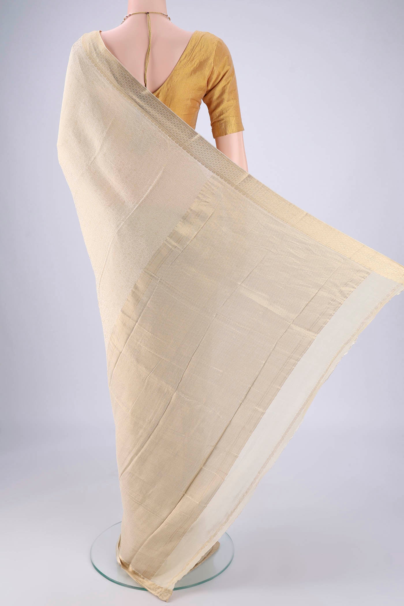 Flat view of Cream Mysore Crepe Saree with Zari Brocade on the body and Zari Border. 