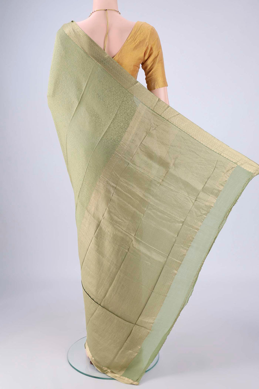 Flat view of Sage Green Mysore Crepe Saree with Zari Brocade on the body and Zari Border. 