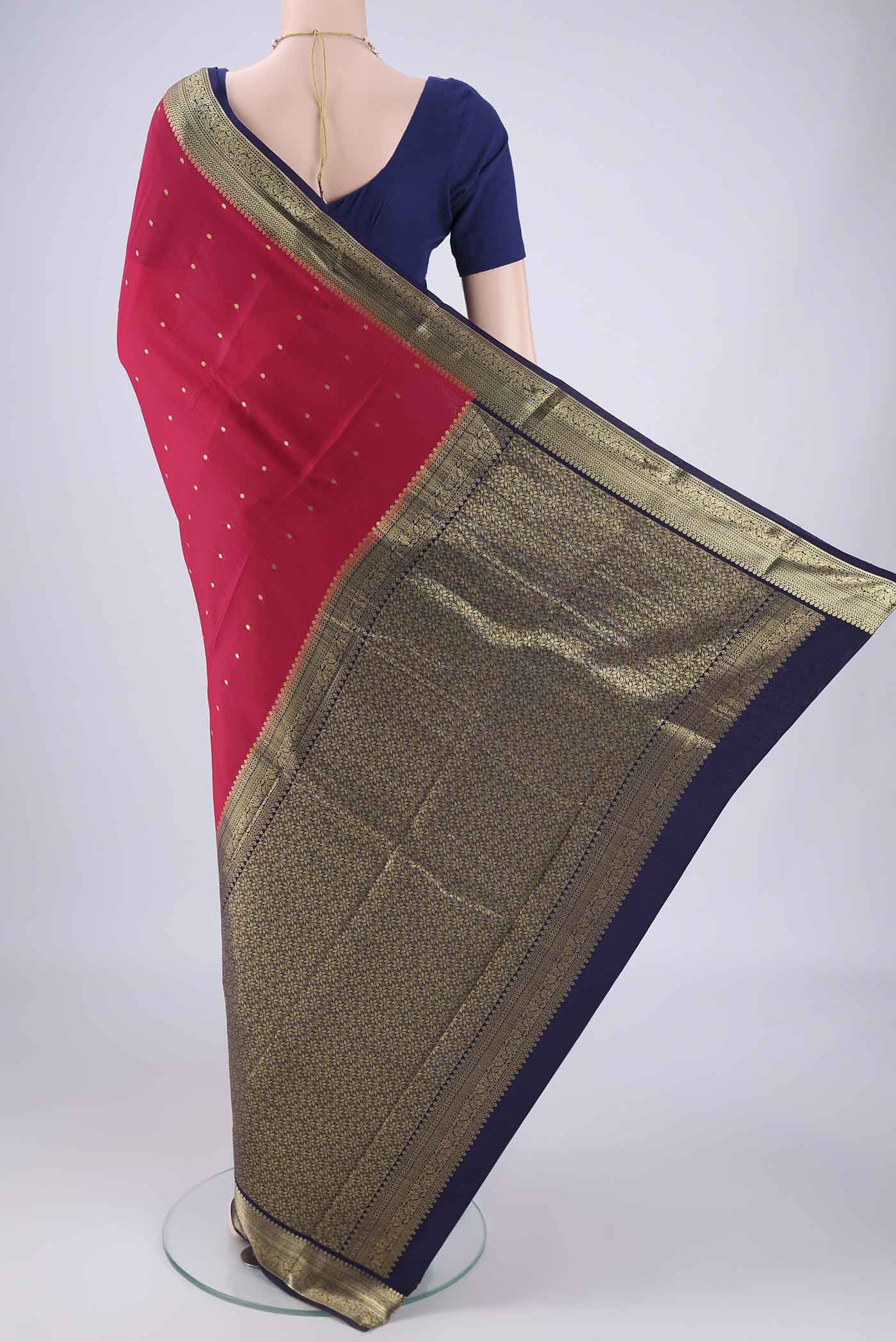 Flat view of Rani Pink Mysore Crepe Saree with Zari Butta on the body and Zari Border. 