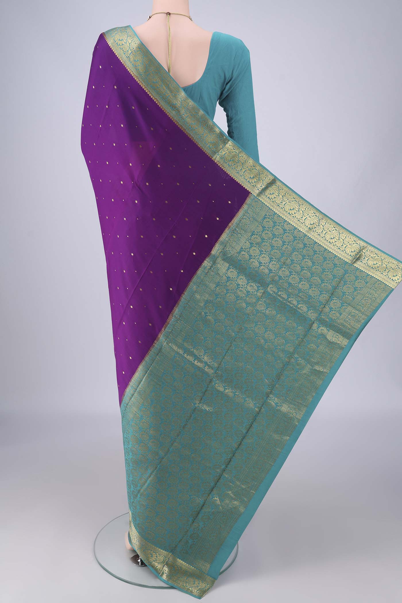 Flat view of Purple Mysore Crepe Saree with Zari Butta on the body and Zari Border. 