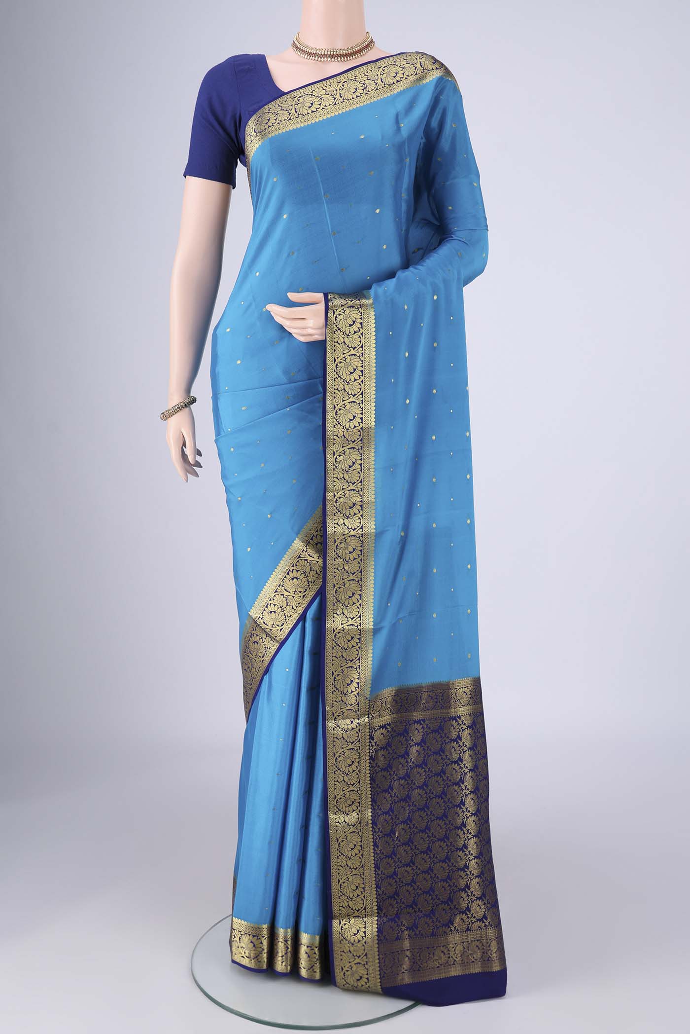 Blue Mysore Crepe Saree with Zari Butta on the body and Zari Border.  displayed on a mannequin