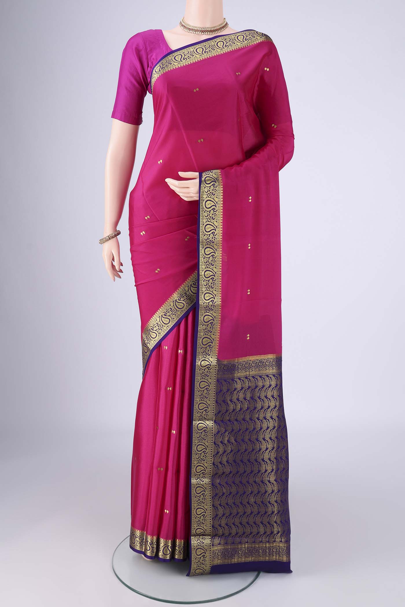 Rani Pink Mysore Crepe Saree with Zari Butta on the body and Zari Border.  displayed on a mannequin