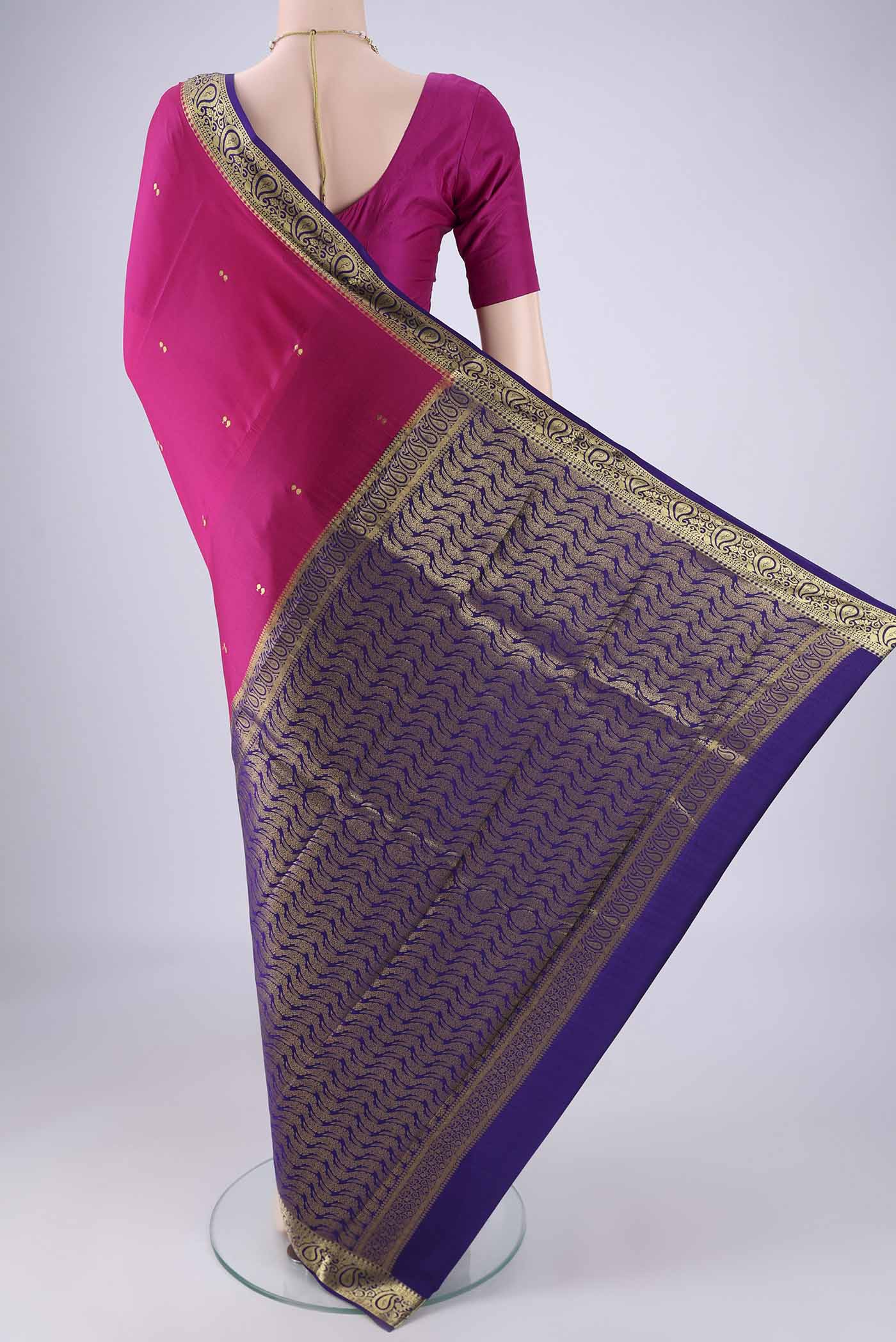 Flat view of Rani Pink Mysore Crepe Saree with Zari Butta on the body and Zari Border. 