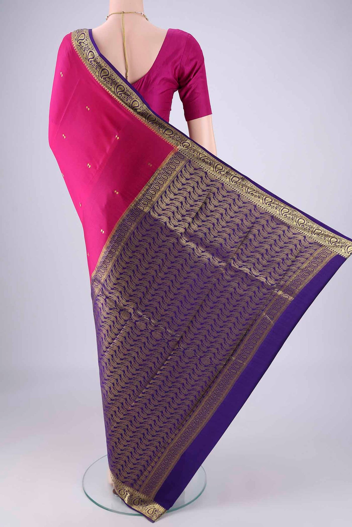 Flat view of Rani Pink Mysore Crepe Saree with Zari Butta on the body and Zari Border. 
