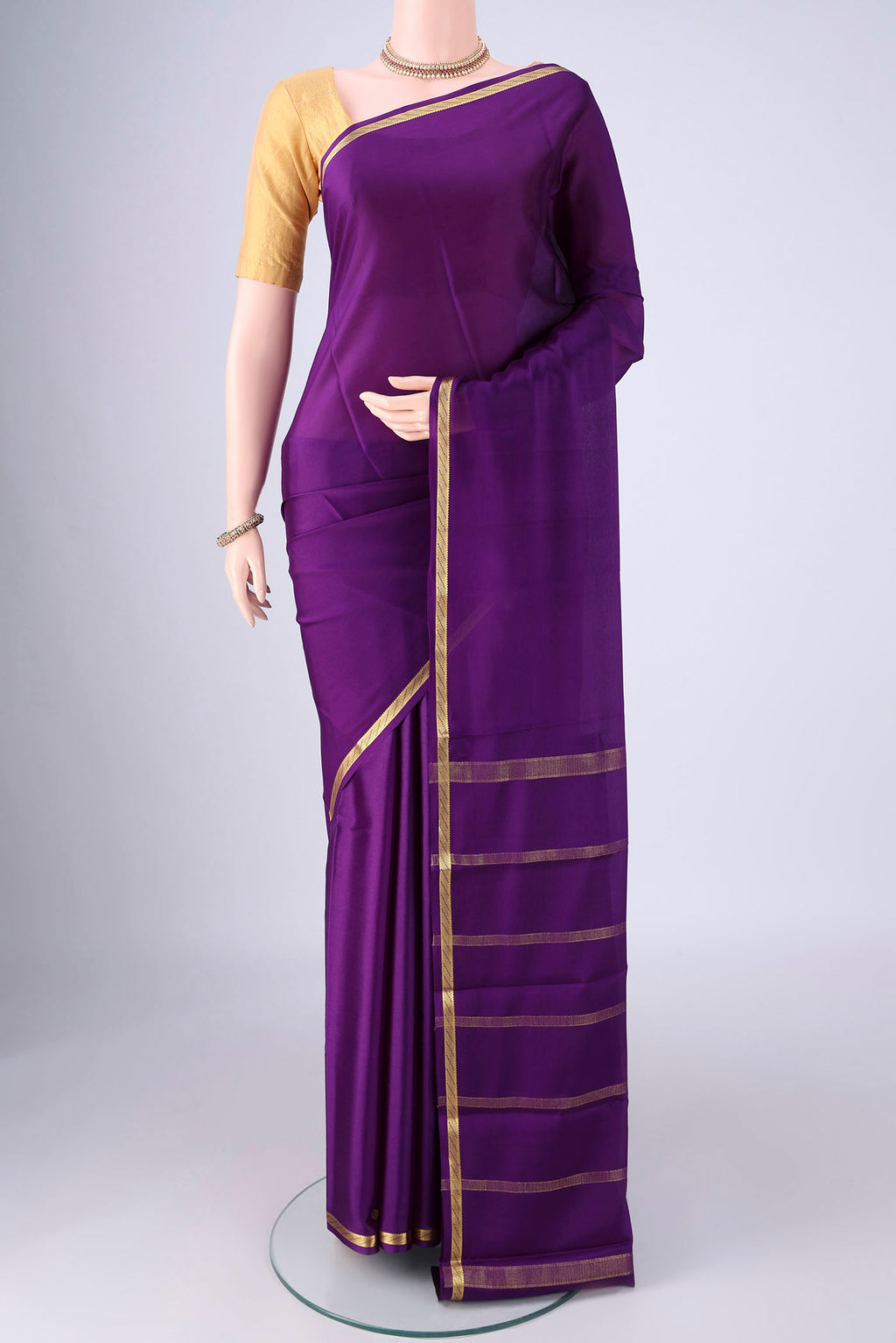 Purple Mysore Crepe Saree with Plain Body and Zari Border.  displayed on a mannequin
