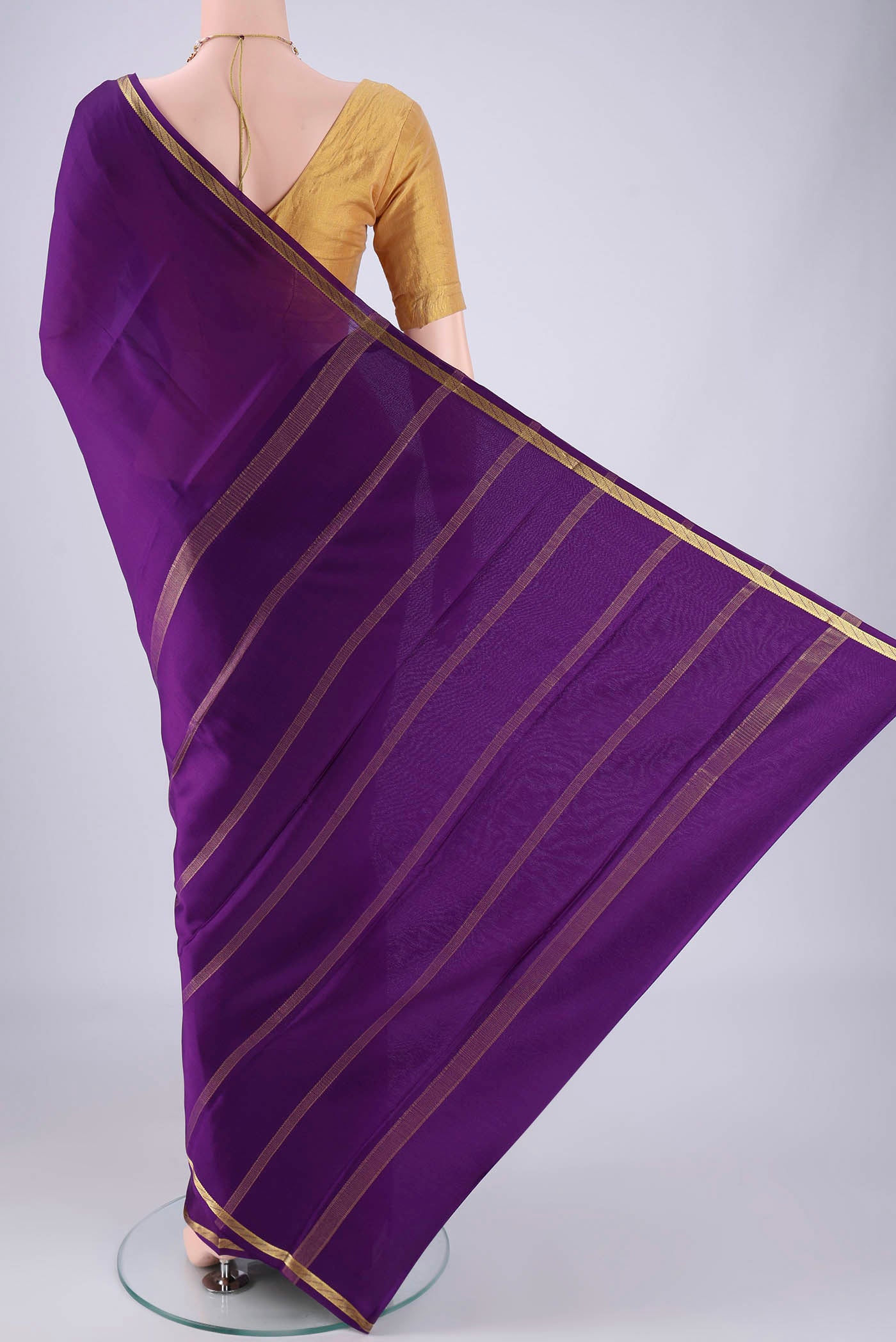 Flat view of Purple Mysore Crepe Saree with Plain Body and Zari Border. 