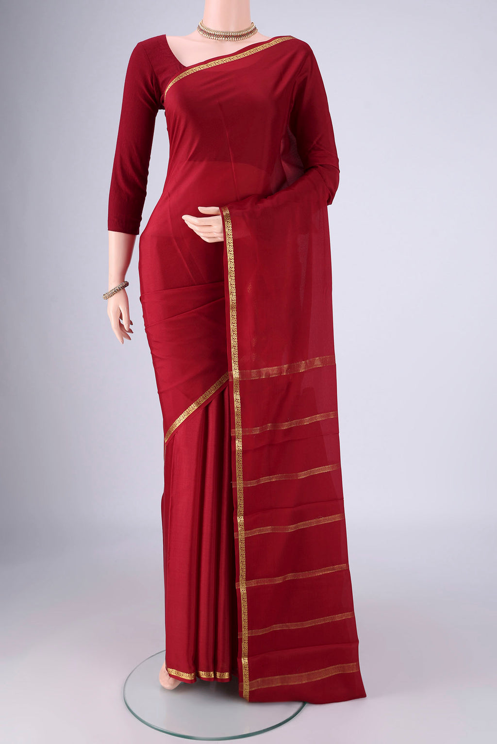 Maroon Mysore Crepe Saree with Plain Body and Zari Border.  displayed on a mannequin