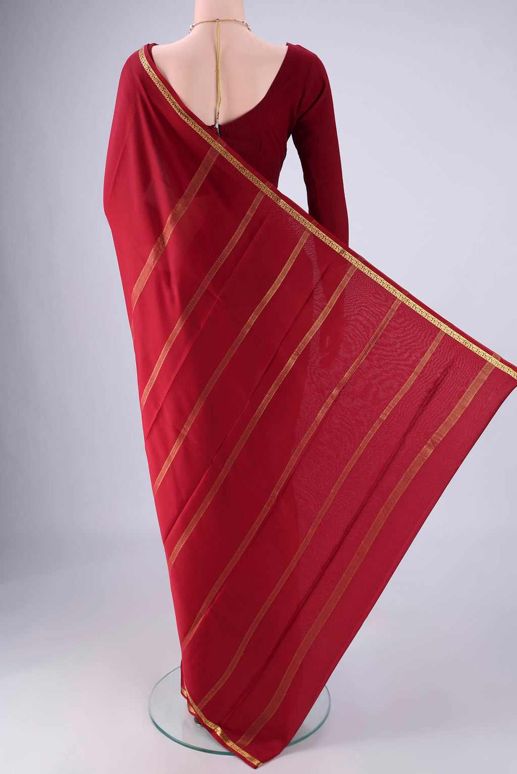 Flat view of Maroon Mysore Crepe Saree with Plain Body and Zari Border. 