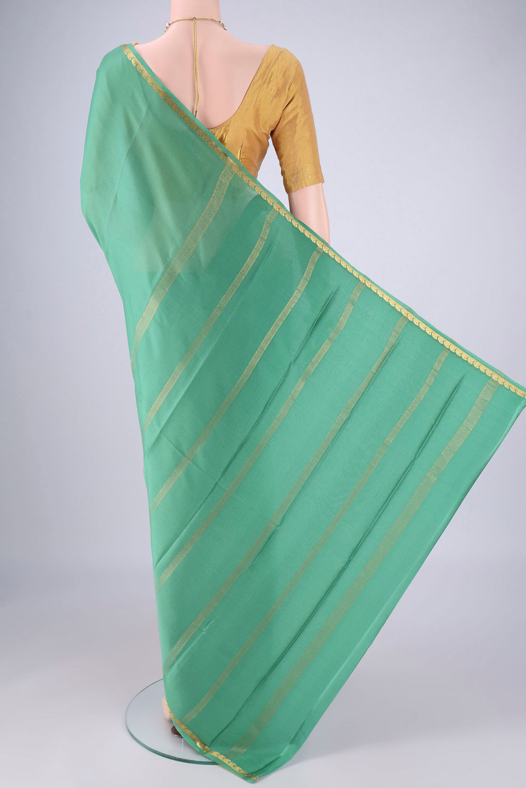 Flat view of Light Green Mysore Crepe Saree with Plain Body and Zari Border. 