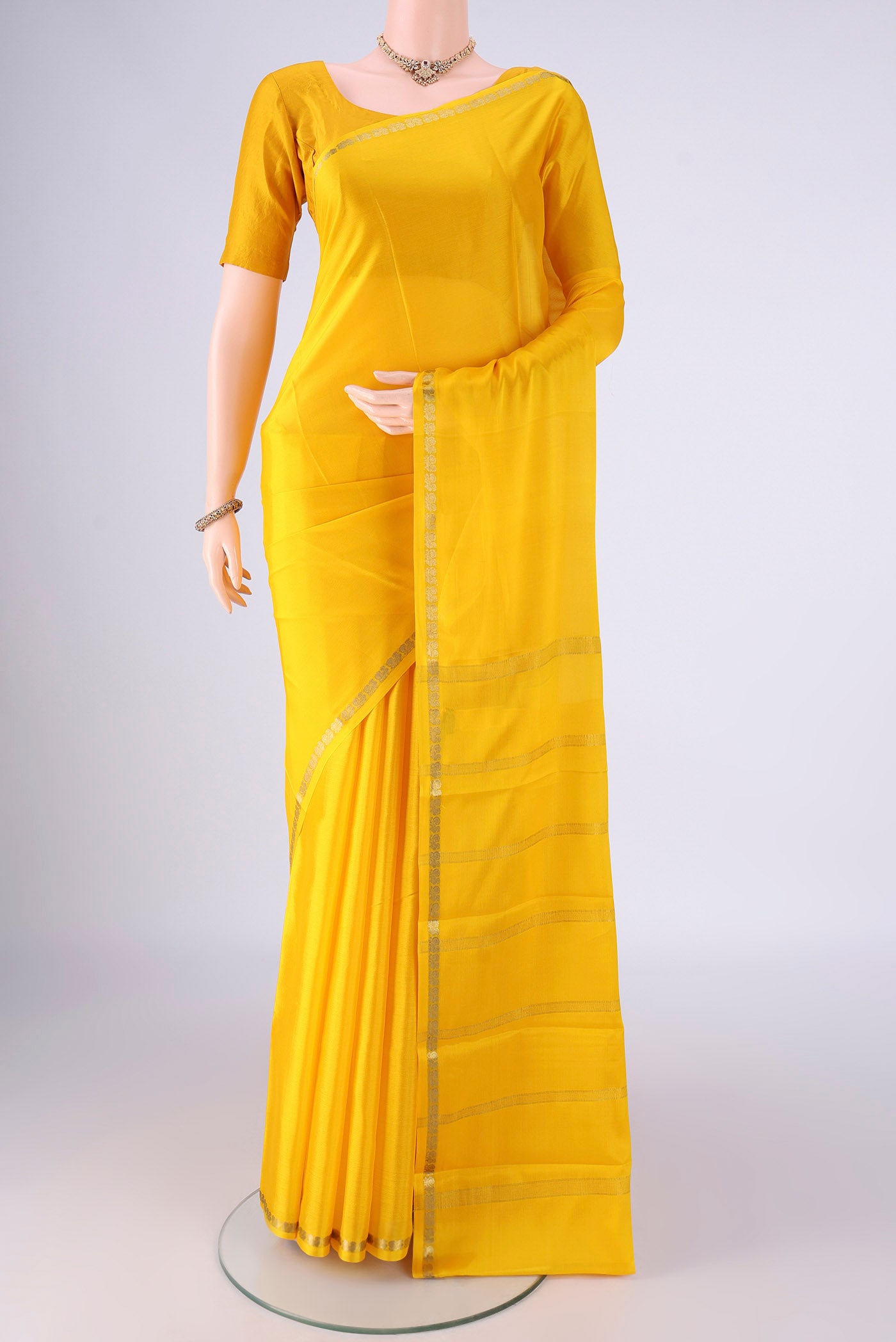 Lemon Yellow Mysore Crepe Saree with Plain Body and Zari Border.  displayed on a mannequin