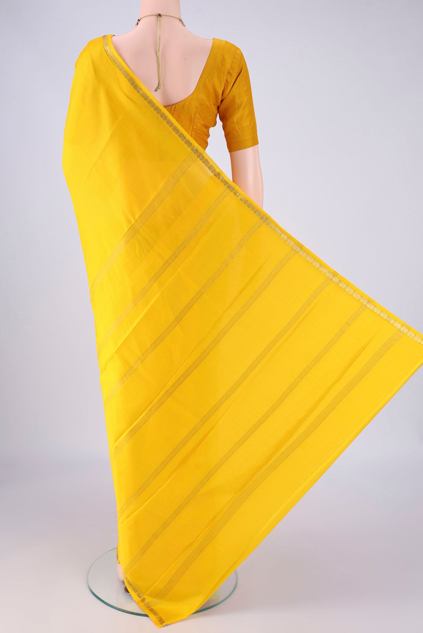 Flat view of Lemon Yellow Mysore Crepe Saree with Plain Body and Zari Border. 