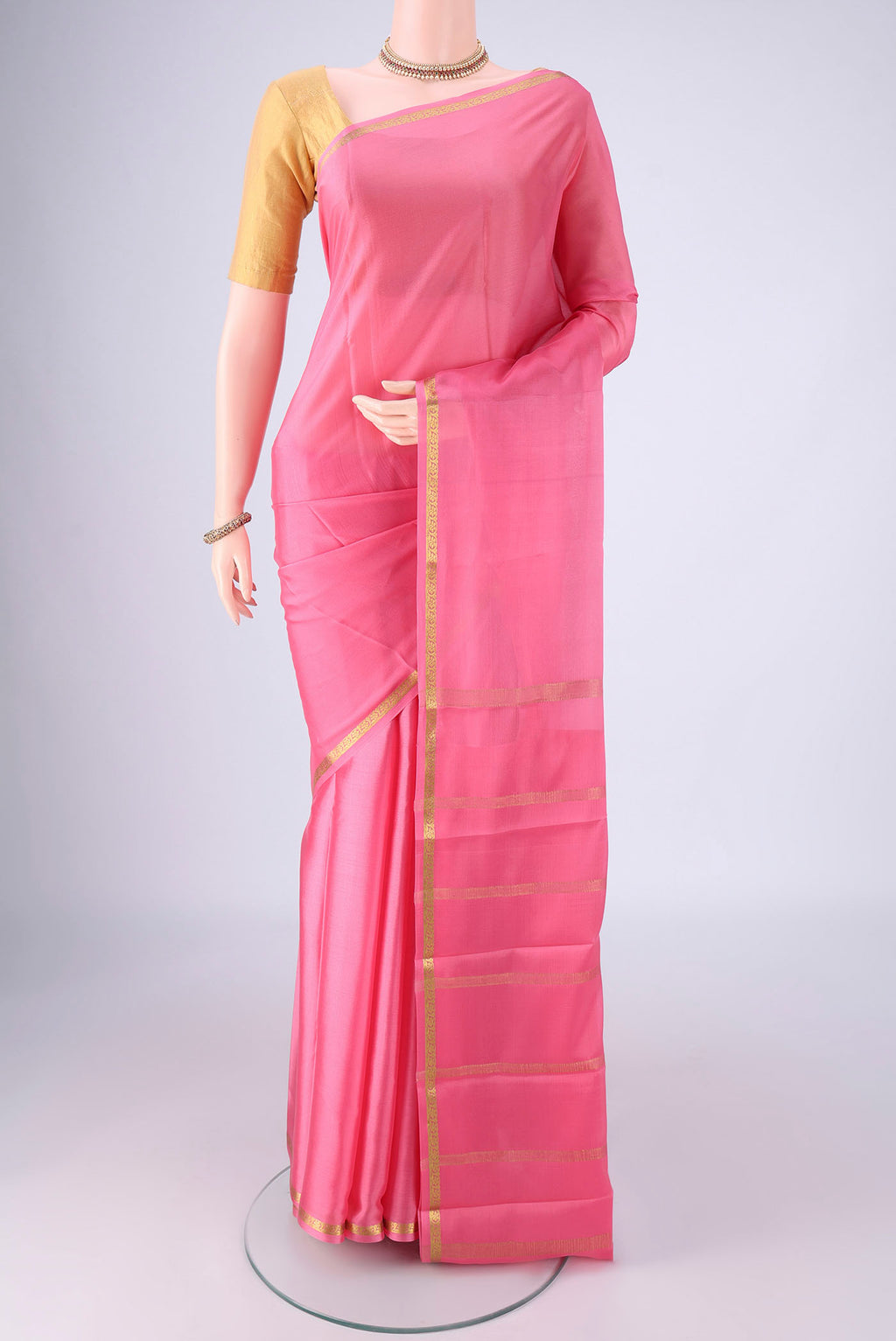 Rose pink Mysore Crepe Saree with Plain Body and Zari Border.  displayed on a mannequin