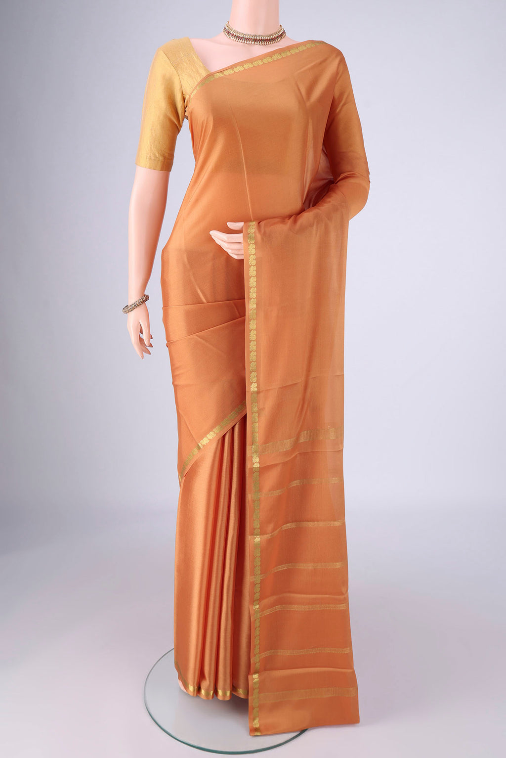 Salmon Mysore Crepe Saree with Plain Body and Zari Border.  displayed on a mannequin
