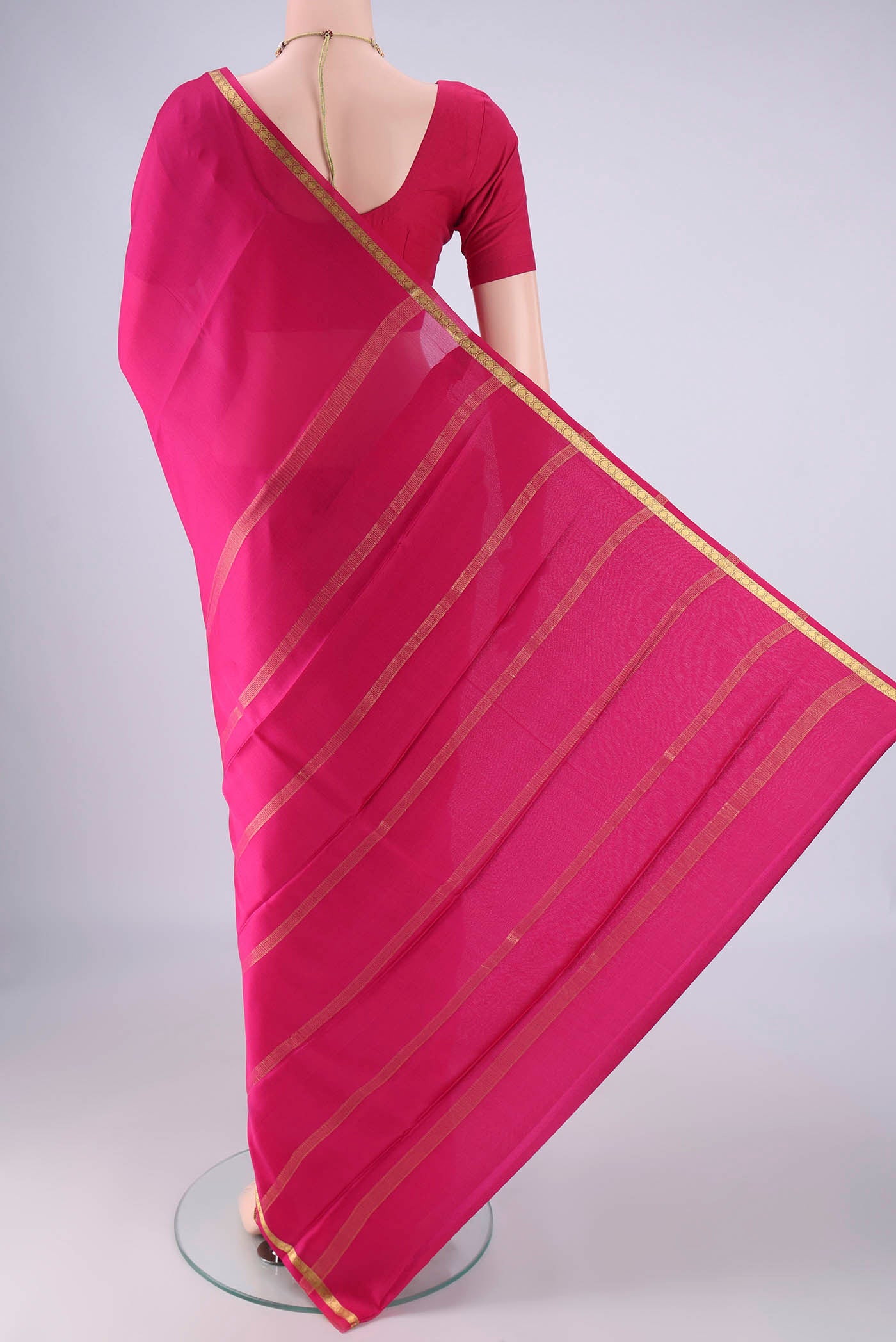 Flat view of Rani Pink Mysore Crepe Saree with Plain Body and Zari Border. 