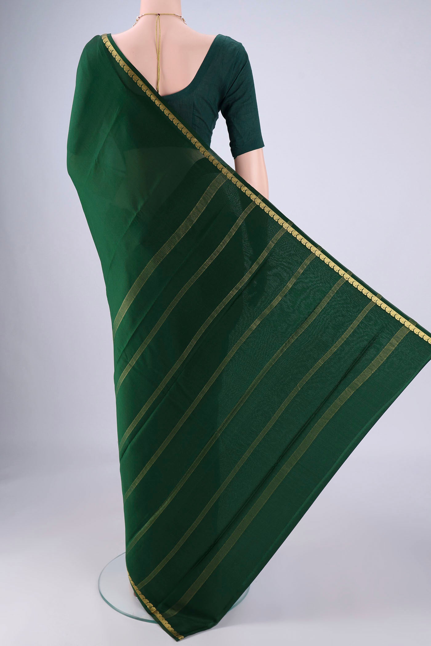 Flat view of Bottle Green Mysore Crepe Saree with Plain Body and Zari Border. 