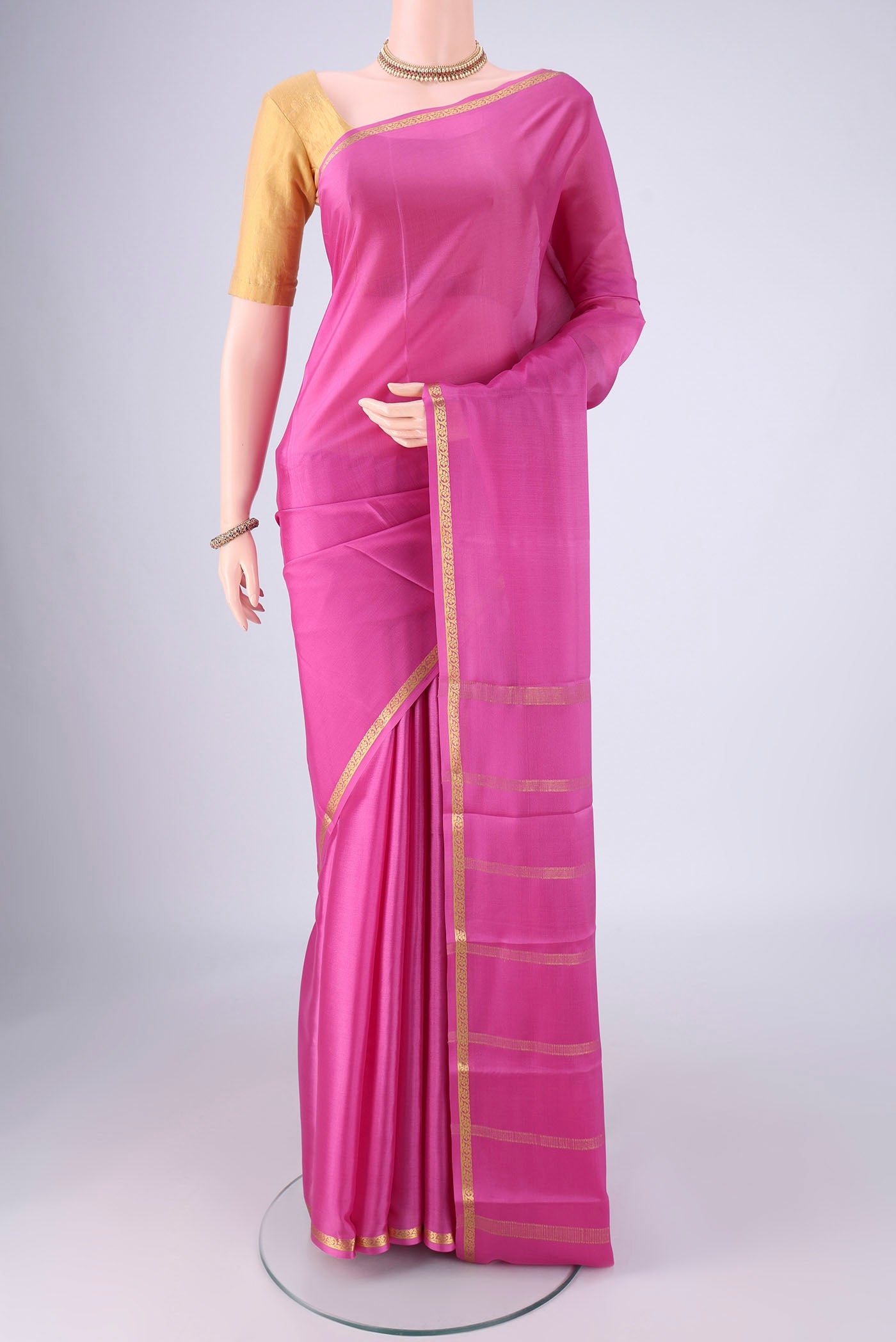 Pink Mysore Crepe Saree with Plain Body and Zari Border.  displayed on a mannequin