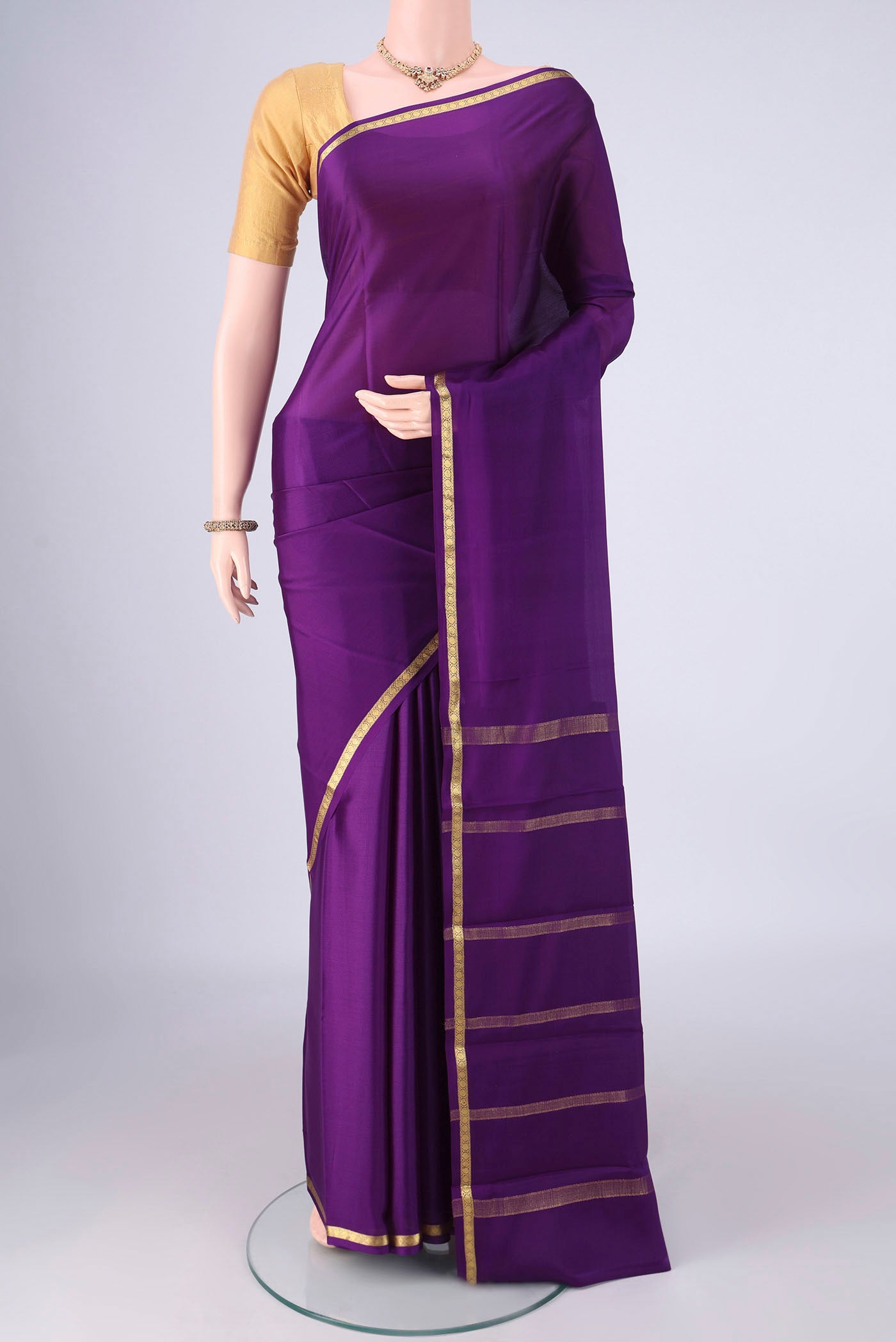 Purple Mysore Crepe Saree with Plain Body and Zari Border.  displayed on a mannequin