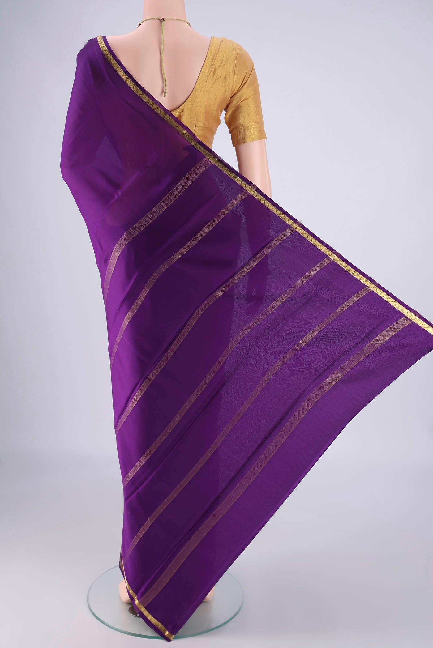 Flat view of Purple Mysore Crepe Saree with Plain Body and Zari Border. 