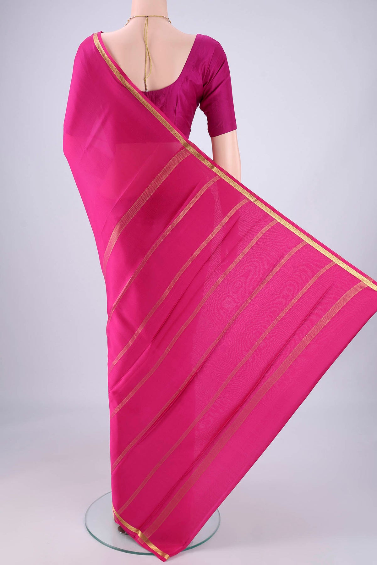 Flat view of Rani Pink Mysore Crepe Saree with Plain Body and Zari Border. 
