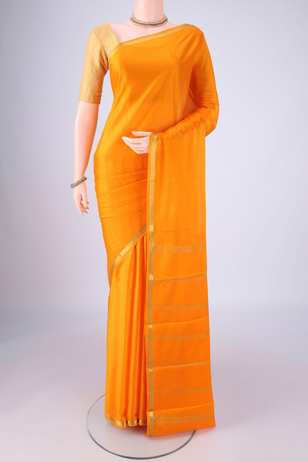 Yellow Mysore Crepe Saree with Plain Body and Zari Border.  displayed on a mannequin